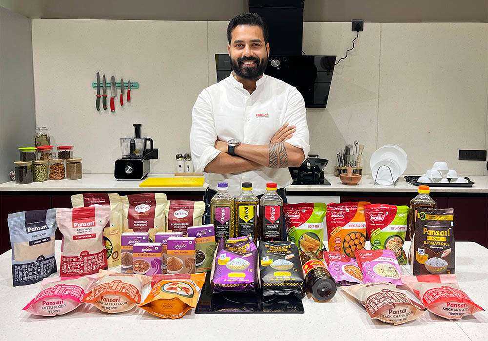 Chairman of Pansari Group standing with a wide range of Pansari food products